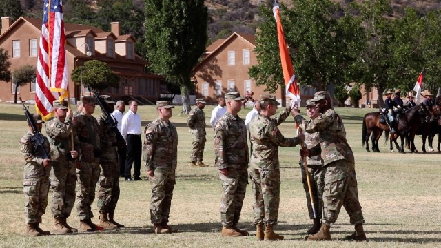 Maj. Gen. Mitchell Kilgo, Commanding General, U.S. Army Communications-Electronics Command passes the unit colors to Col. Daniel Wood, incoming Commander of the U.S. Army Information Systems Engineering Command at a change of command ceremony on...
