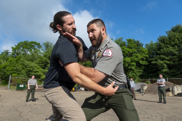 Vincent Klinkner (right), park ranger, and Chris Schuster, natural resource specialist with the U.S. Army Corps of Engineers Pittsburgh District, demonstrate self-defense tactics at Crooked Creek Lake in Ford City, Pennsylvania, June 15, 2021, as...