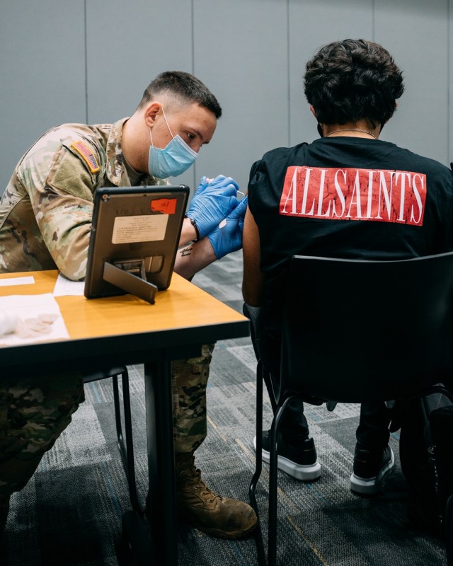 Nevada National Guard Spc. Austin Czarnecki of Joint Task Force 17 administers the Janssen vaccine to a patient at the College of Southern Nevada Cheyenne campus in Las Vegas Jun. 23, 2021.