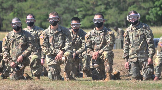 Soldiers of the 262nd Quartermaster Battalion watch as a Black Hawk helicopter lands at McLaney Drop Zone during the quartermaster field training exercise June 17. The students practiced refueling the aircraft without fuel.