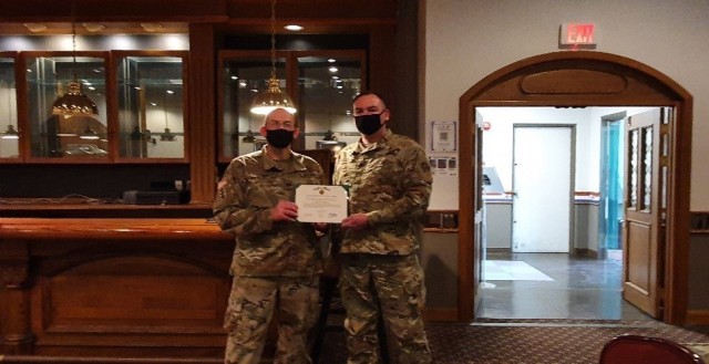 Far East District Commander, COL Christopher Crary, presents SSG Timothy Sepkoski, Southern Resident Office Quality Assurance Rep, with an end-of-service award. Upon separation from the Army, Sepkoski will join SRO as a Civilian. (FED file photo)