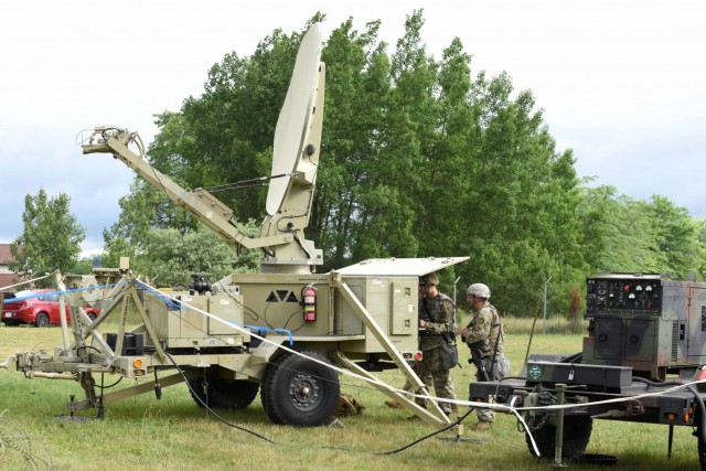 U.S. Army Pvt. Nathan Kipp, left, and U.S. Army Cpl. Morgan Long, 156th Expeditionary Signal Battalion, Michigan Army National Guard, set up signal communications during annual training, Fort Custer Training Center, Augusta, Michigan, June 21,...