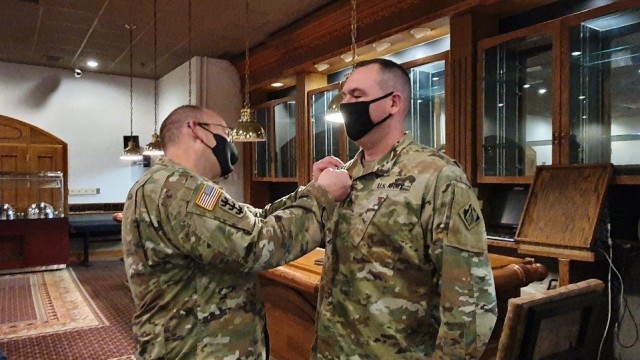 Far East District Commander, COL Christopher Crary, presents SSG Timothy Sepkoski, Southern Resident Office Quality Assurance Rep, with an end-of-service award. Upon separation from the Army, Sepkoski will join SRO as a Civilian. (FED file photo)