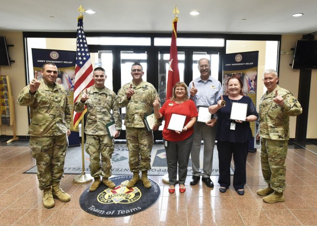 At a ceremony June 28 in Hoge Hall, Maj. Gen. James Bonner, Maneuver Support Center of Excellence and Fort Leonard Wood commanding general (right), and MSCoE and Fort Leonard Wood Command Sgt. Maj. Randolph Delapena (left) presented two-star notes to Army Emergency Relief Officer Chuck Matthews and his team. 1st Lt. Rom Pollack and Sgt. 1st Class Steven Hooper each also received Army Commendation Medals for their roles as volunteer coordinators. The 2021 AER fundraising campaign here was named No. 1 in the Army, with $213,405 raised and 53.9 percent of Soldiers donating.