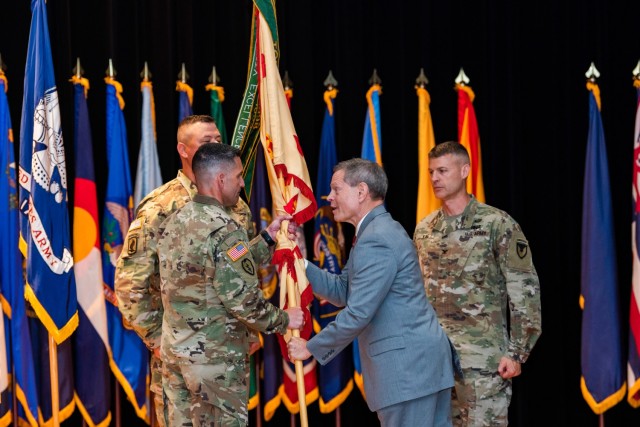 Director of Installation Management Command-Training Vincent Grewatz passes the Fort Knox Garrison colors to incoming commander Col. Lance O’Bryan June 30 at Waybur Theater.
