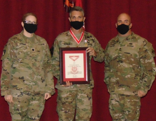 Colonel Mark Geraldi displays his Silver deFleury medal and certificate he received as a surprise from Transatlantic Division Commander, BG Kimberly Colloton. Sharing this moment with the outgoing Expeditionary District Commander is LTC Stephanie...