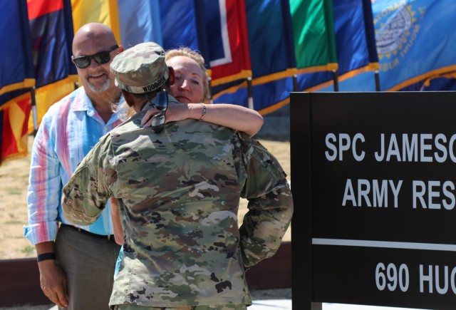 After the unveiling of the Spc. Jameson L. Lindskog U.S. Army Reserve Center plaque during the building memorialization ceremony, left, Mr. Curtis Lindskog, his father, pauses, as Maj. Gen. Jonathan Woodson, commanding general, Army Reserve Medical Command, embraces Mrs. Jo Lindskog, Lindskog&#39;s stepmother, as a show of support, June 29, 2021 at Parks Reserve Forces Training Area in Dublin, Calif. Lindskog, a resident of Pleasanton, Calif., was killed in action March 29, 2011 while serving as a combat medic with the 2nd Battalion, 327th Infantry Regiment, 1st Brigade Combat Team, 101st Airborne Division in Afghanistan. He posthumously received the Silver Star for his heroic actions that day. 
(Photo by Sgt. 1st Class Matthew Chlosta)