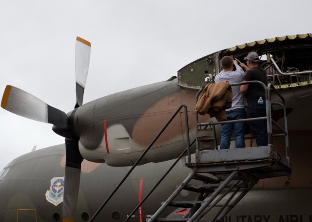 (From left) U.S. Air Force Airman 1st Class Quintin Parrott and Airman 1st Class Jacob Scott, both crew chiefs with the 62nd Aircraft Maintenance Squadron, ensure a C-130E Hercules is ready to be towed at Joint Base Lewis-McChord, Washington, June...