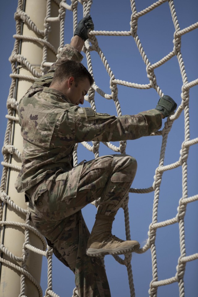 U.S. Army Spc. Omar H. Dacosta, an Infantryman with Company A, 3rd Battalion, 172nd Infantry (Mountain), 86th Brigade Infantry Combat Team (Mountain),  climbs down a rope ladder during the U.S. Army Central 2021 Best Warrior Competition obstacle...