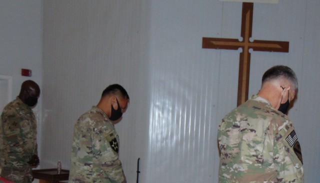One of the most significant pauses a Soldier takes while deployed is the invocation and Colonel Ken Reed, SGM Jun Tomagan, and Colonel Mark Geraldi share this moment during the Change of Command Ceremony at Camp Arifjan, Kuwait on June 28, 2021....