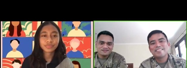 Maj. Melvin Cabebe and Sgt. Joshua Fale, members of the 9th Mission Support Command’s Task Force Oceania Pacific Augmentation Team assigned to Timor-Leste, engage with a student volunteer as part of a live-streamed virtual event with UmaAmerika...