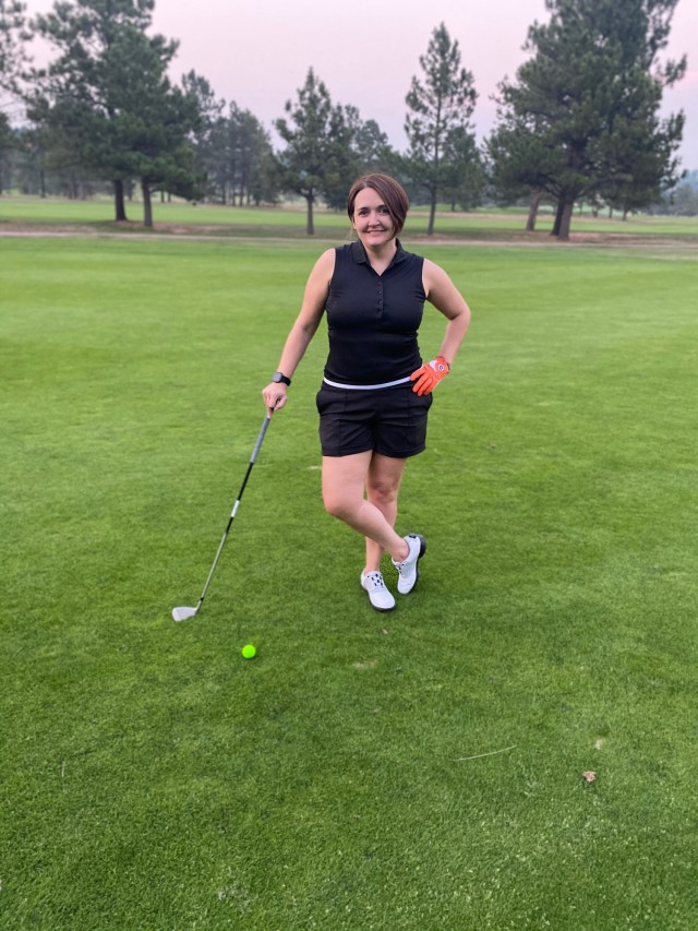 Maj. Adriana de Julio of the Fort Carson Soldier Recovery Unit in Colorado poses on a golf course. She will be competing in golf at the 2021 DoD Warrior Games in September as well as in several other sports. (Photo via Maj. Adriana de Julio)