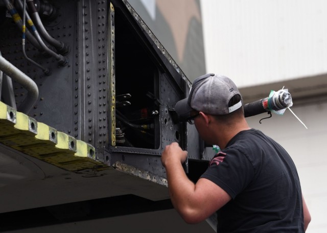 U.S. Air Force Senior Airman Jacob Scott, 62nd Aircraft Maintenance Squadron crew chief, works on a C-130E Hercules at Joint Base Lewis-McChord, Washington, June 13. 2021. The 62nd AMXS worked alongside several other units in order to coordinate...