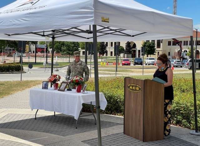 Mariangiola Miller, USAG Italy’s ACS director, and Col. Dan Vogel, USAG Italy&#39;s commander, lead a June 30, 2021 ceremony to honor the life of Chief Warrant Officer 2 James R. Harbeson and dedicate the Child Development Center in his memory.