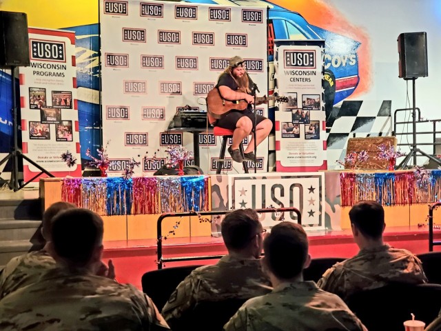 Artist Chris Kroeze sings a song June 15, 2021, during his 90-minute concert at Fort McCoy, Wis. He entertained dozens of audience members in McCoy's Community Center during a concert that was organized by Wisconsin USO and supported by the Fort...