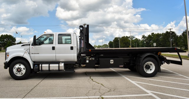 Crane Army Ammunition Activity’s hook trucks are outfitted with Stellar hooks and beds that can be raised and lowered in order to deliver a forklift to magazines and other facilities across the installation. Hook trucks allow depot operations to move materiel without having equipment prepositioned at the magazine by another vehicle or government agency. | Photo by Lindsay Grant, Crane Army Ammunition Activity Public Affairs Office