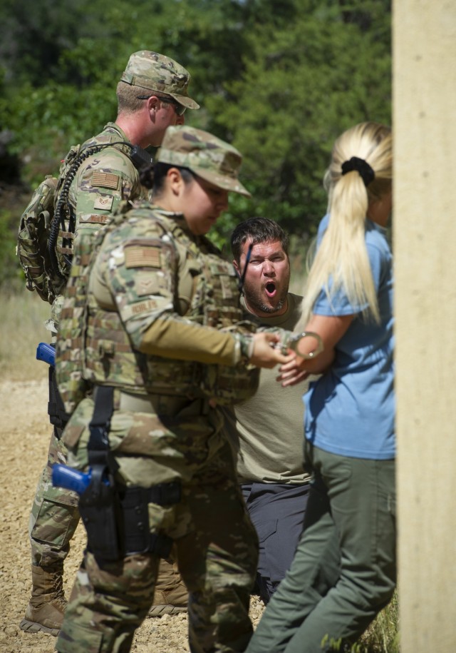 U.S. Air Force security forces members wear civilian clothing and simulate a domestic disturbance at a training area June 16, 2021. during the National Guard Patriot '21 exercise at Fort McCoy, Wis. Multiple Air Force SF and civilian...