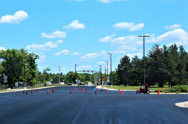 Work by contractors with Scott Construction of Lake Delton, Wis., for seal-coating work is shown on the roadway near the Main Gate on June 2, 2021, at Fort McCoy, Wis. The project, coordinated by the Fort McCoy Directorate of Public Works,...
