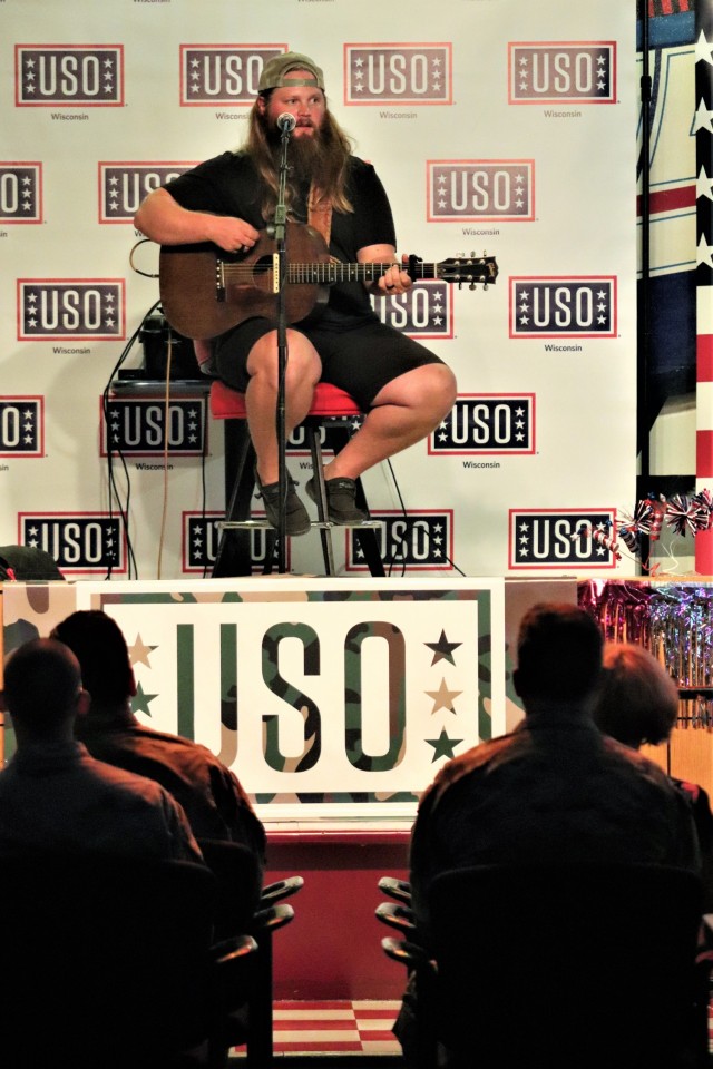 Artist Chris Kroeze sings a song June 15, 2021, during his 90-minute concert at Fort McCoy, Wis. He entertained dozens of audience members in McCoy's Community Center during a concert that was organized by Wisconsin USO and supported by the Fort...