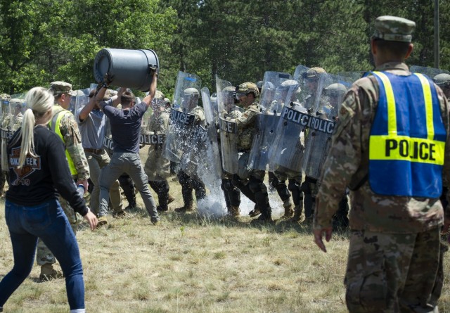 U.S. Air Force security forces members wear civilian clothing and simulate a domestic disturbance at a training area June 16, 2021, during the National Guard Patriot '21 exercise at Fort McCoy, Wis. Multiple Air Force SF and civilian...