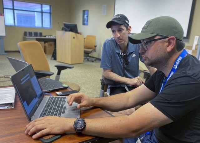 Richard Gonzales, left, senior cyber security lead, watches Gerardo Trevino, right, both assigned to Joint Base San Antonio 5th Generation (5G) Program Management Office, work through lessons during the 5G Cell on Light Truck (CoLT) training, June...