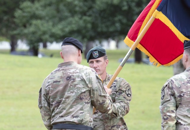 Col. Kent G. Solheim, 165th Infantry Brigade commander, receives the unit colors from Fort Jackson Commander Brig. Gen. Patrick R. Michaelis during a change of command ceremony June 29 at VIctory Field. Solheim took charge of the unit from Col. Eric Flesch.