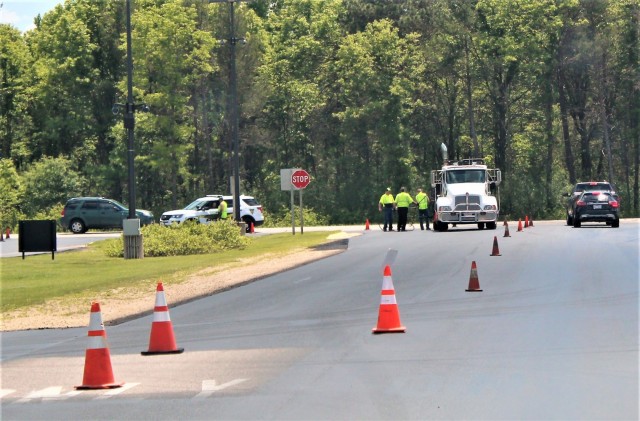 Contractors with Scott Construction of Lake Delton, Wis., complete seal-coating work on the roadway near the Main Gate on June 2, 2021, at Fort McCoy, Wis. The project, coordinated by the Fort McCoy Directorate of Public Works, consisted of...