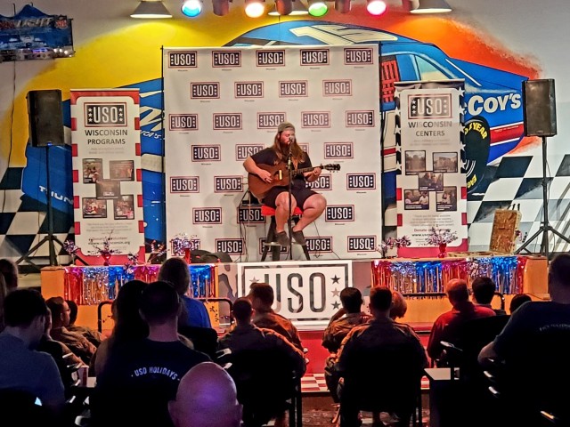 Artist Chris Kroeze sings a song June 15, 2021, during his 90-minute concert at Fort McCoy, Wis. He entertained dozens of audience members in McCoy's Community Center during a concert that was organized by Wisconsin USO and supported by the Fort...