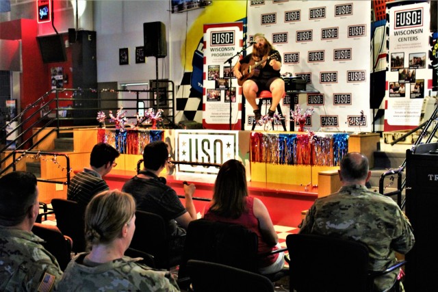 Artist Chris Kroeze sings a song June 15, 2021, during his 90-minute concert at Fort McCoy, Wis. He entertained dozens of audience members in McCoy's Community Center during a concert that was organized by Wisconsin USO and supported by the Fort...