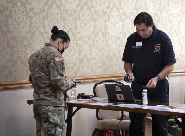 Will Sexton, Fort Jackson Fire Inspector and blood drive ambassador, helps check in a volunteer to the Community Blood Drive held June 28 at the NCO Club.