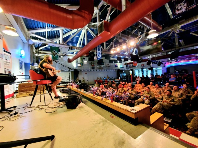 Artist Chris Kroeze sings a song June 15, 2021, during his 90-minute concert at Fort McCoy, Wis. He entertained dozens of audience members in McCoy's Community Center during a concert that was organized by Wisconsin USO and supported by the Fort...