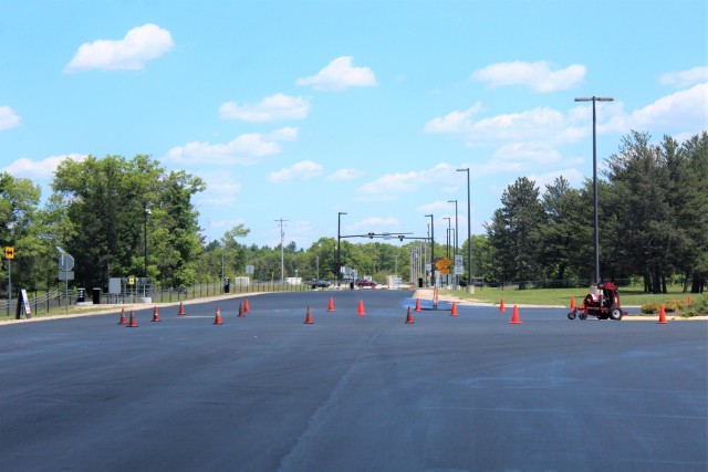 Work by contractors with Scott Construction of Lake Delton, Wis., for seal-coating work is shown on the roadway near the Main Gate on June 2, 2021, at Fort McCoy, Wis. The project, coordinated by the Fort McCoy Directorate of Public Works,...