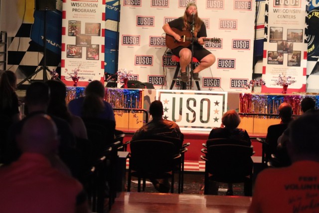 Entertainer and musician Chris Kroeze sings a song June 15, 2021, during his 90-minute concert at Fort McCoy, Wis. He entertained dozens of audience members in McCoy's Community Center during a concert that was organized by Wisconsin USO and supported by the Fort McCoy Directorate of Family and Morale, Welfare and Recreation. Kroeze is a native of Barron, Wis., and is a national recording artist. Kroeze rose to national attention during his participation in the hit TV singing competition, The Voice, during the 2018 season. He nearly won the competition — earning runner-up honors. (U.S. Army Photo by Scott T. Sturkol, Public Affairs Office, Fort McCoy, Wis.)