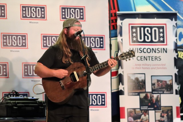 Artist Chris Kroeze sings a song June 15, 2021, during his 90-minute concert at Fort McCoy, Wis. He entertained dozens of audience members in McCoy's Community Center during a concert that was organized by Wisconsin USO and supported by the Fort...