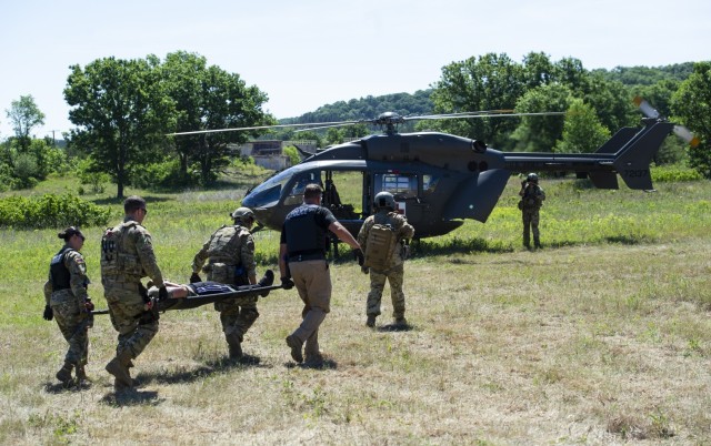 Air Force security forces and civilian law enforcement members load a simulated casualty on to a U.S. Army UH-72 Lakota helicopter during a simulated medical evacuation exercise June 16, 2021, at Fort McCoy, Wis. The action was part of the...