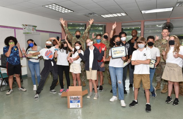 Antilles Middles School seventh graders proudly display their Fort Buchanan Garrison Certificates of Appreciation presented by garrison leadership for their commendable initiative in support of our deployed troops.