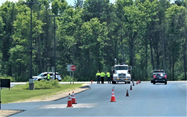 Contractors with Scott Construction of Lake Delton, Wis., complete seal-coating work on the roadway near the Main Gate on June 2, 2021, at Fort McCoy, Wis. The project, coordinated by the Fort McCoy Directorate of Public Works, consisted of...