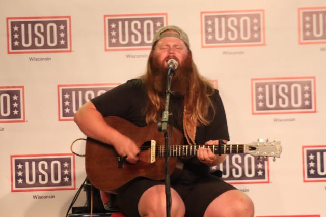 Entertainer and musician Chris Kroeze sings a song June 15, 2021, during his 90-minute concert at Fort McCoy, Wis. He entertained dozens of audience members in McCoy's Community Center during a concert that was organized by Wisconsin USO and supported by the Fort McCoy Directorate of Family and Morale, Welfare and Recreation. Kroeze is a native of Barron, Wis., and is a national recording artist. Kroeze rose to national attention during his participation in the hit TV singing competition, The Voice, during the 2018 season. He nearly won the competition — earning runner-up honors. (U.S. Army Photo by Scott T. Sturkol, Public Affairs Office, Fort McCoy, Wis.)