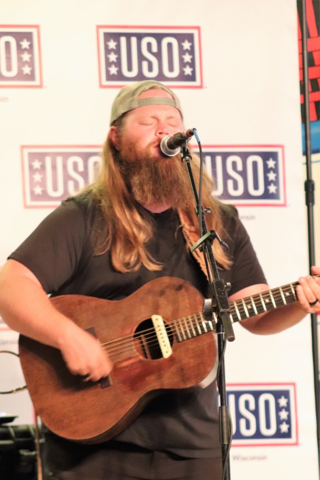 Artist Chris Kroeze sings a song June 15, 2021, during his 90-minute concert at Fort McCoy, Wis. He entertained dozens of audience members in McCoy's Community Center during a concert that was organized by Wisconsin USO and supported by the Fort...