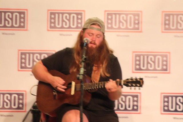 Artist Chris Kroeze sings a song June 15, 2021, during his 90-minute concert at Fort McCoy, Wis. He entertained dozens of audience members in McCoy's Community Center during a concert that was organized by Wisconsin USO and supported by the Fort...