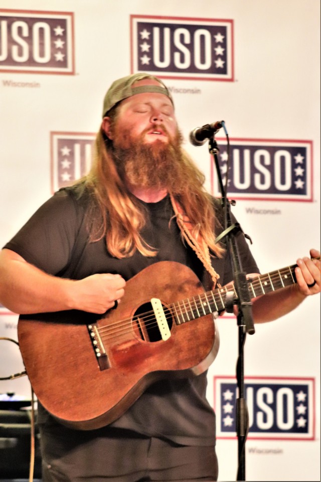 Artist Chris Kroeze sings a song June 15, 2021, during his 90-minute concert at Fort McCoy, Wis. He entertained dozens of audience members in McCoy's Community Center during a concert that was organized by Wisconsin USO and supported by the Fort...