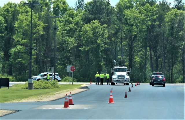 Contractors with Scott Construction of Lake Delton, Wis., complete seal-coating work on the roadway near the Main Gate on June 2, 2021, at Fort McCoy, Wis. The project, coordinated by the Fort McCoy Directorate of Public Works, consisted of...