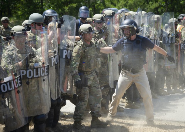 U.S. Air Force security forces members wear civilian clothing and simulate a domestic disturbance at a training area June 16, 2021, during the National Guard Patriot '21 exercise at Fort McCoy, Wis. Multiple Air Force SF and civilian...