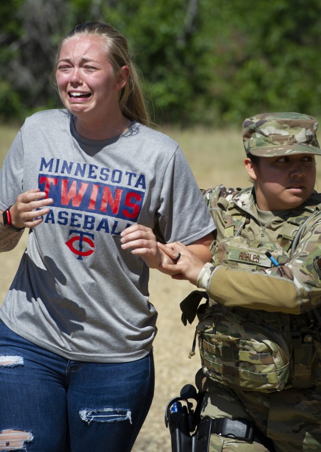 U.S. Air Force security forces members wear civilian clothing and simulate a domestic disturbance at a training area June 16, 2021, during the National Guard Patriot '21 exercise at Fort McCoy, Wis. Multiple Air Force SF and civilian...