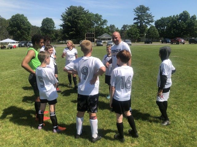 Sgt. 1st Class Nicholas Huebbe, the senior paralegal noncommissioned officer for the 181st Multifunctional Training Brigade, laughs at a joke told by one of his players during the halftime of a game June 5, 2021, in Tomah, Wis. Huebbe has been a...