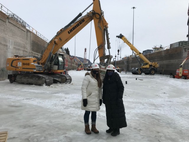 Courtney Emmerich, equal employment opportunity manager, and Lupe Santos-Jensen, equal employment opportunity specialist, stand in the dewatered lock chamber at Lock and Dam 4 near Alma, Wisconsin, Feb. 12.