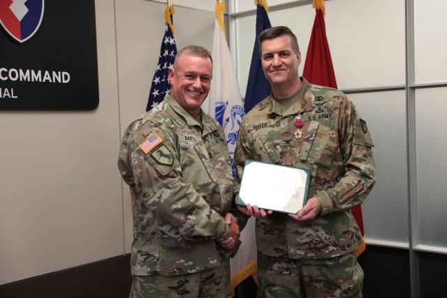 Army Materiel Command Chief of Staff Maj. Gen. Bob Harter presents AMC Command Surgeon Col. Matt Hoefer with the Legion of Merit. (U.S. Army photo by Megan Gully)