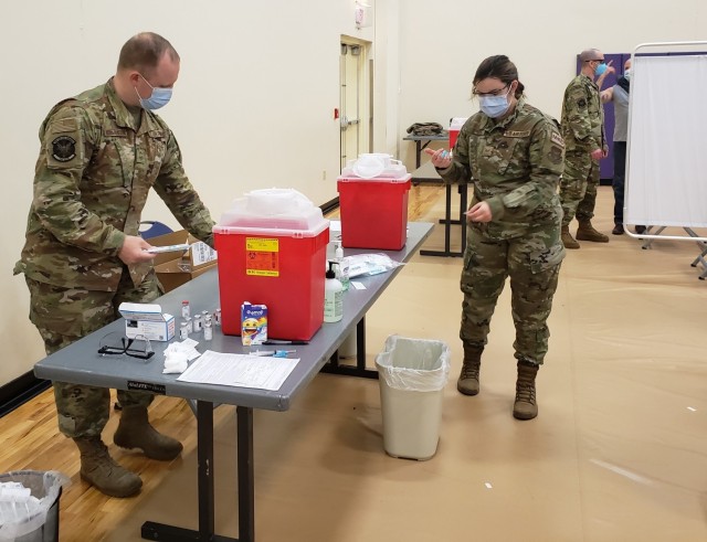 Air Force Reserve aeromedical technicians prepare to administer the COVID-19 vaccination to Corps employees, April 27.