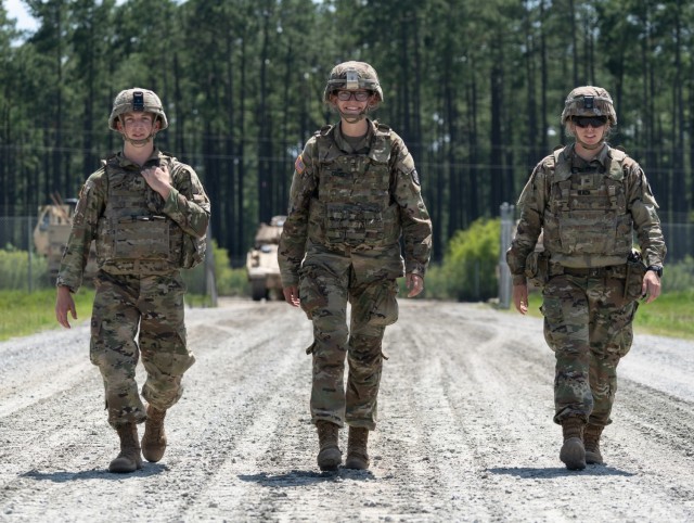 Cadets Paul Budoff, left, Danielle Cross, center, and Annesley Black, right, walk to an M2 Bradley Fighting Vehicle to participate in a gunnery with 9th Brigade Engineer Battalion, 2nd Armored Brigade Combat Team, 3rd Infantry Division, during...