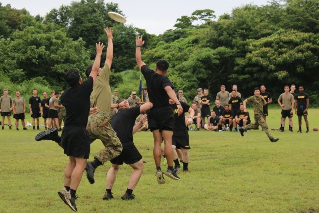 Soldiers assigned to 1st Battalion, 28th Infantry Regiment, 3rd Infantry Division, and members of Japan Ground Self-Defense Force jump to catch a Frisbee during an ultimate Frisbee tournament on Aibano Training Area, Japan, July 2, 2021. Soldiers...